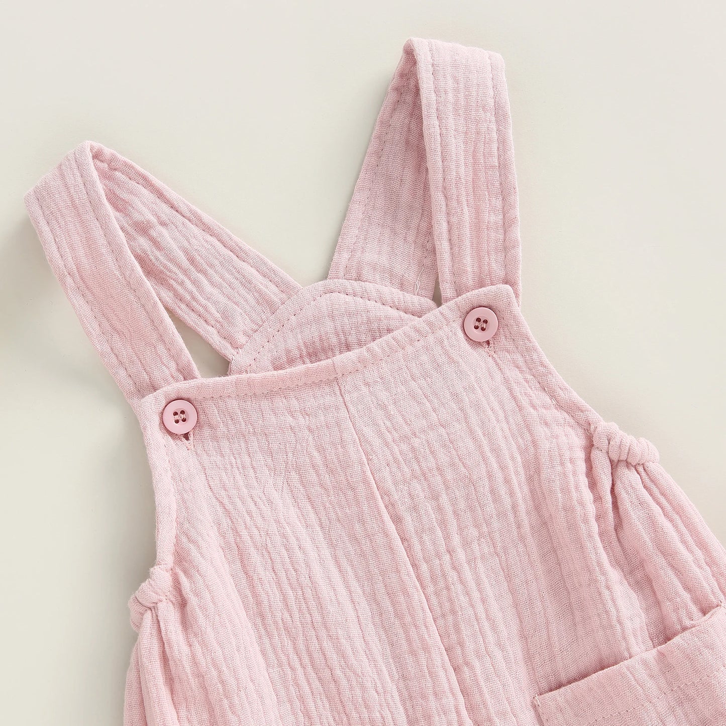 Somrig babyromper med hängslen
