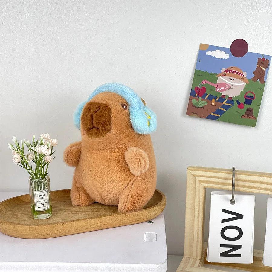 Söt capybara nyckelring med hörlurar