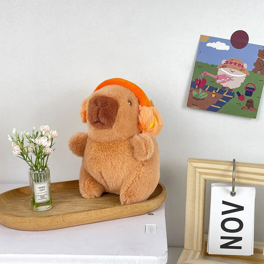 Söt capybara nyckelring med hörlurar