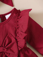 Babyklänning med volangkant & rosett