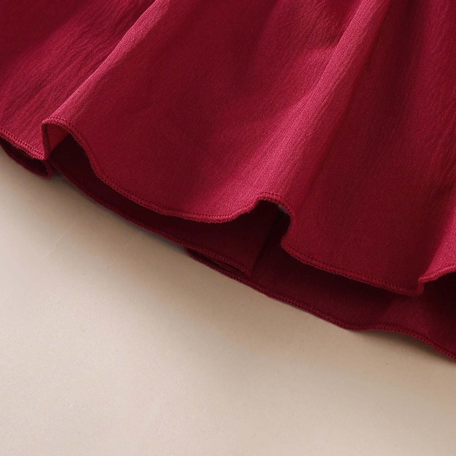 Babyklänning med volangkant & rosett